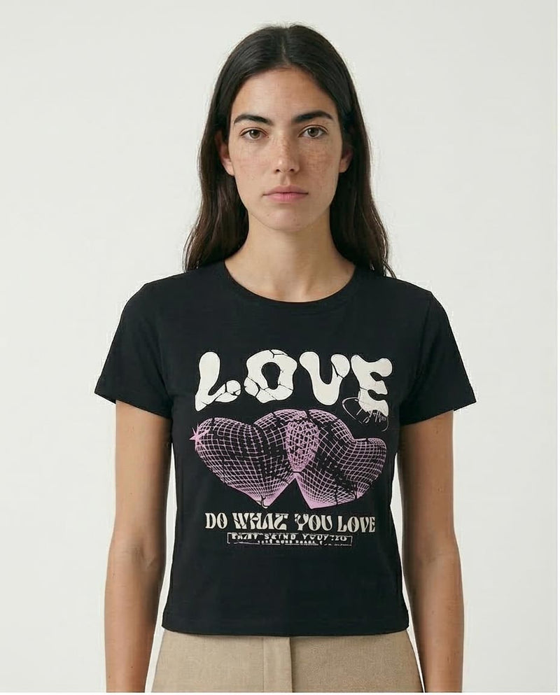 Person wearing a black t-shirt with a graphic design and text.