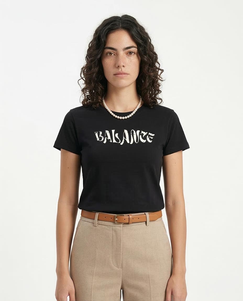 Person wearing a black t-shirt with 'BALANCE' text on a white background