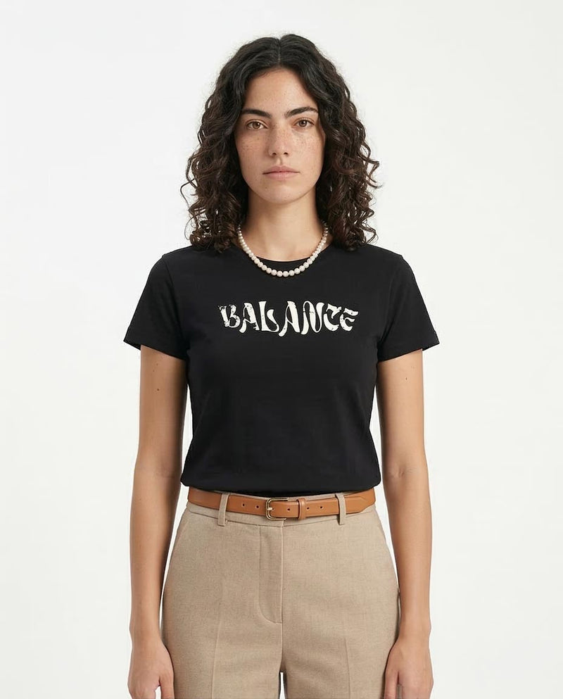 Person wearing a black t-shirt with 'BALANCE' text on a white background