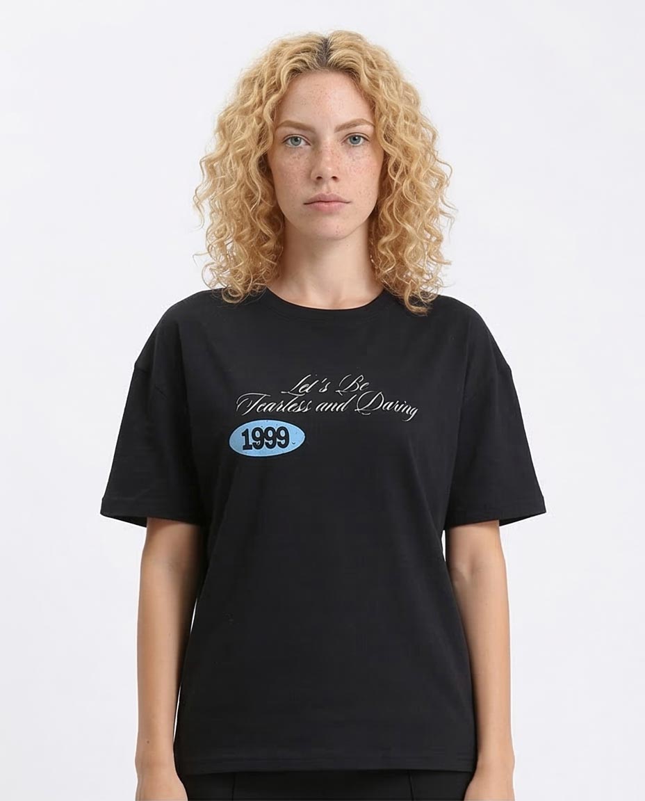 Person wearing a black t-shirt with '1999' text on a white background