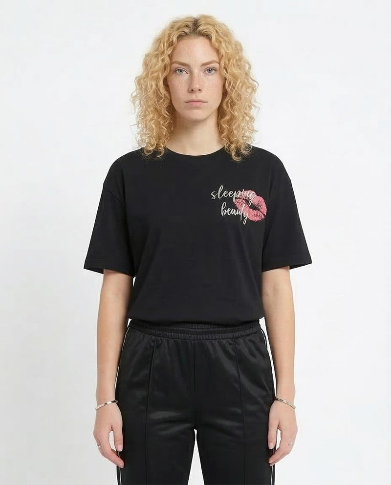 Person wearing a black t-shirt with '"Coffee First' text on a white background