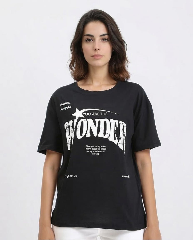 Woman wearing a black t-shirt with white text on a white background