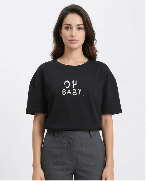 Woman wearing a black t-shirt with 'OH BABY' text on a white background