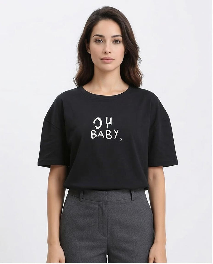 Woman wearing a black t-shirt with 'OH BABY' text on a white background