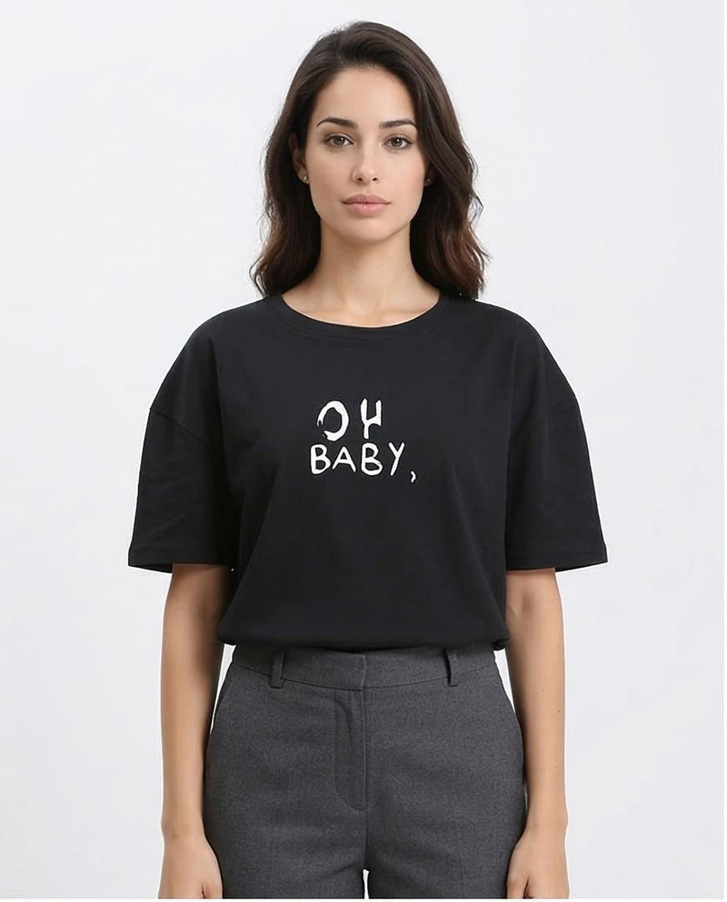 Woman wearing a black t-shirt with 'OH BABY' text on a white background