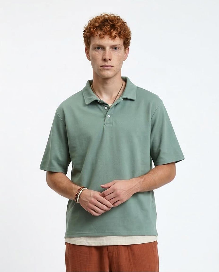 Man wearing a green polo shirt on a white background
