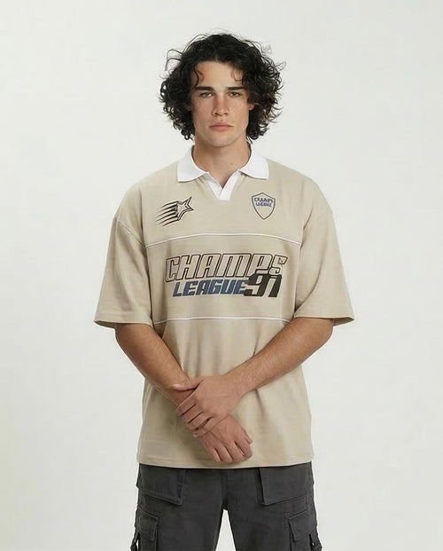 Person wearing a beige sports jersey with branding on a white background