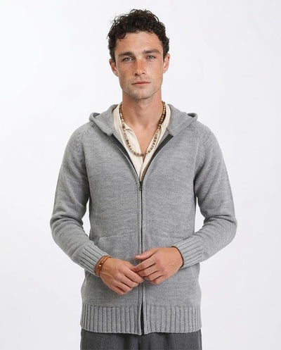 Man wearing a gray zip-up hoodie on a white background