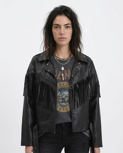 Person wearing a black leather jacket with fringe details on a white background
