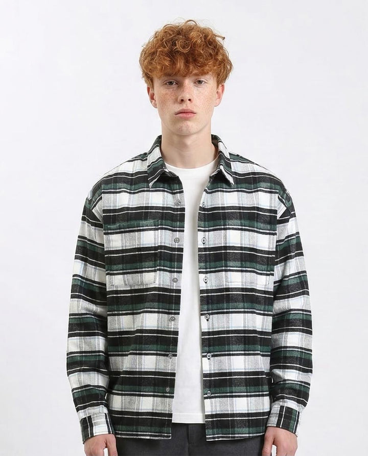 Man wearing a black and white plaid shirt over a white t-shirt on a white background