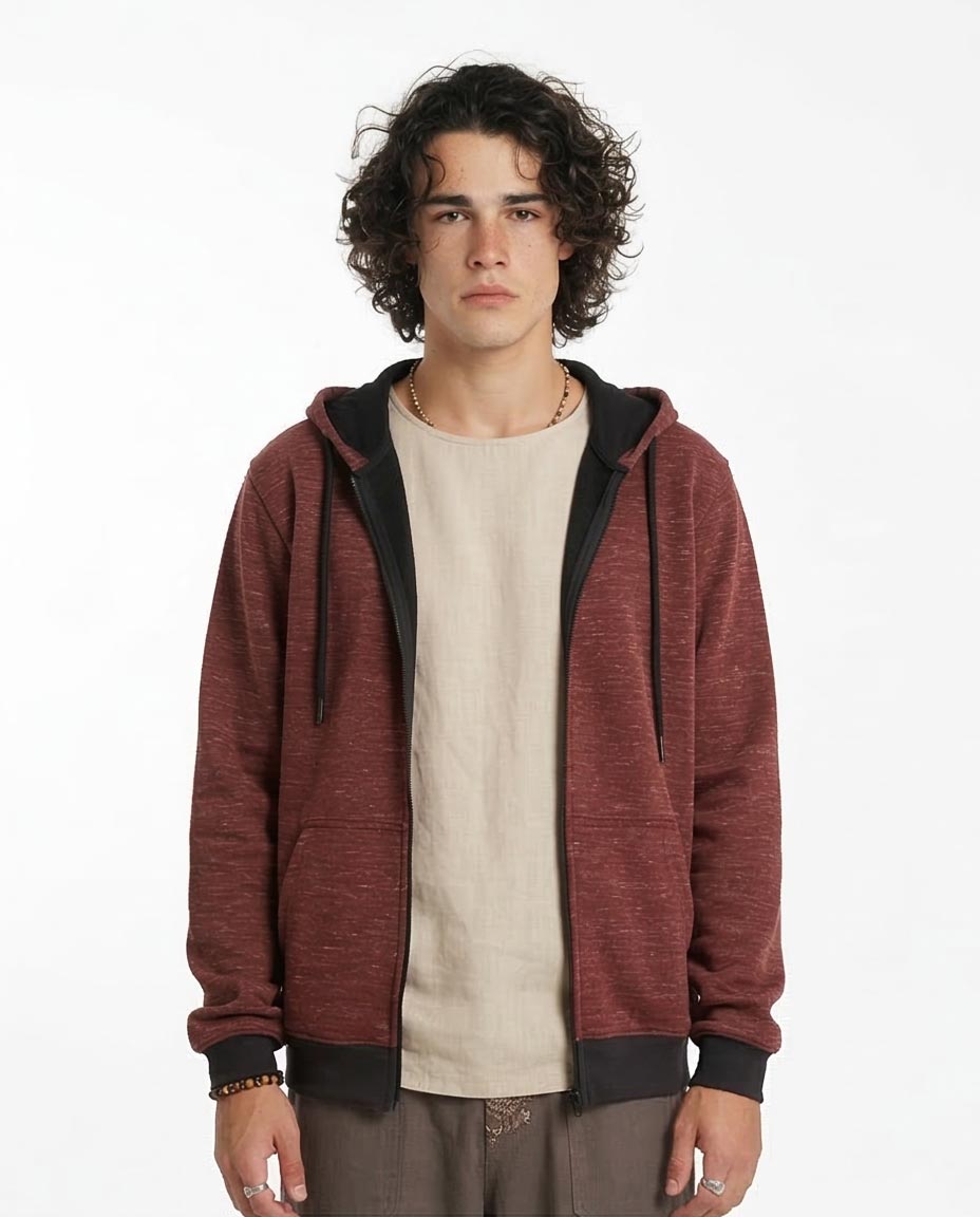 Man wearing a red hoodie over a beige shirt on a white background