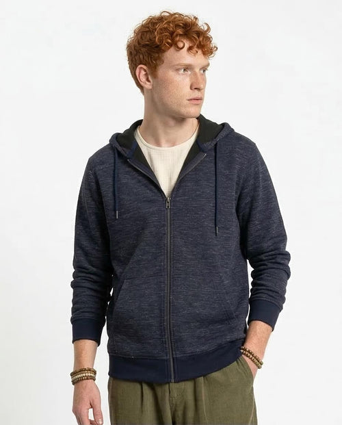 Man wearing a navy blue hoodie with a white background