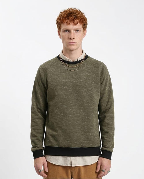 Man wearing a green sweater with a white background