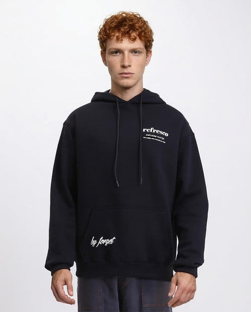 Man wearing a black hoodie with text on a white background