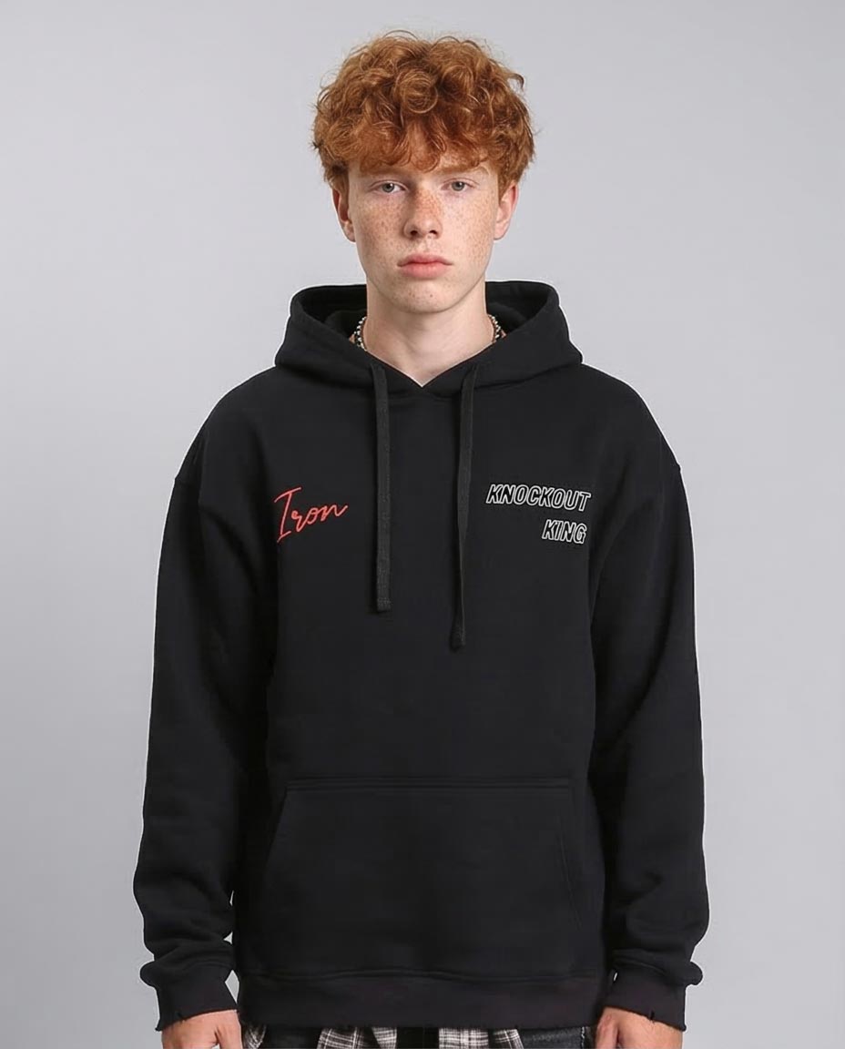 Person wearing a black hoodie with text on a gray background