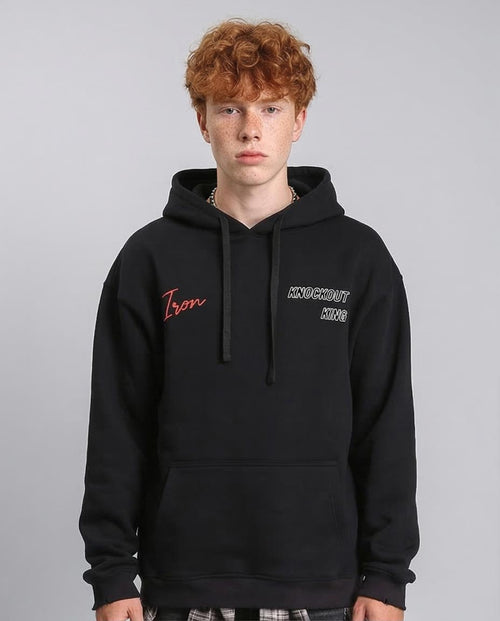 Person wearing a black hoodie with text on a gray background