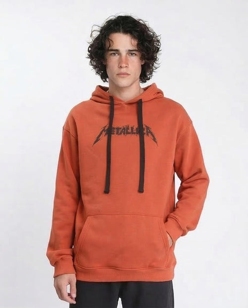 Person wearing an orange hoodie with a brand logo on a white background