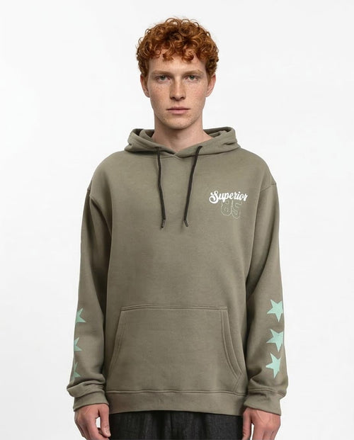 Man wearing a green hoodie with a brand logo on a white background