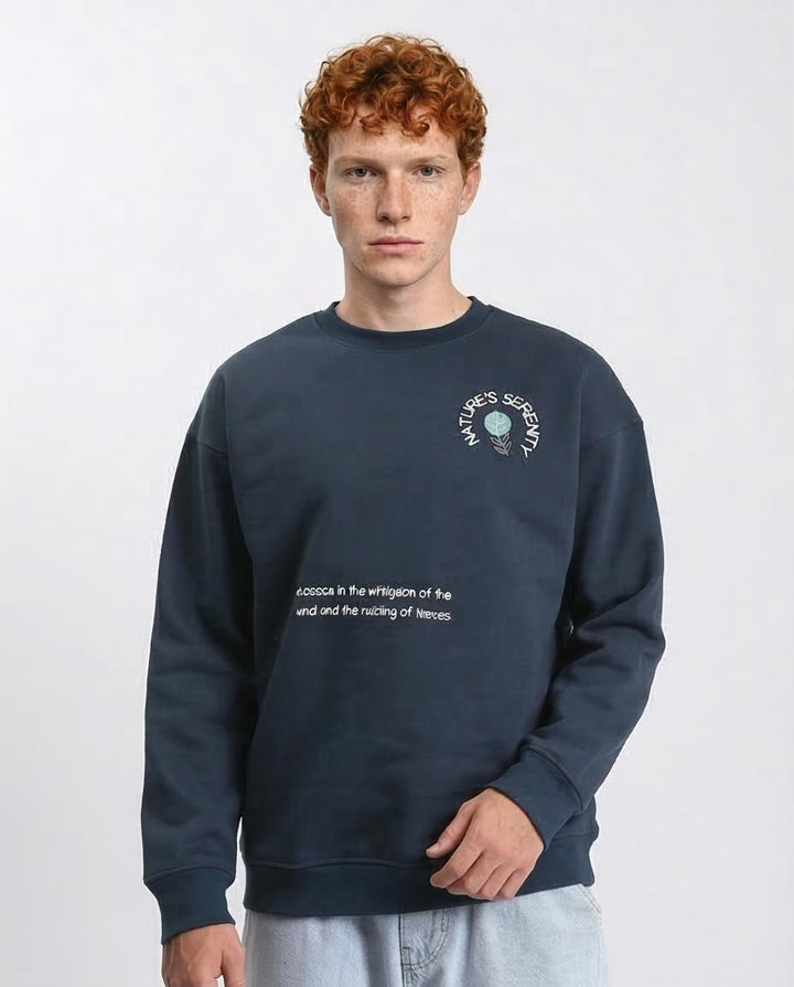 Man wearing a navy blue sweatshirt with text and logo on a white background