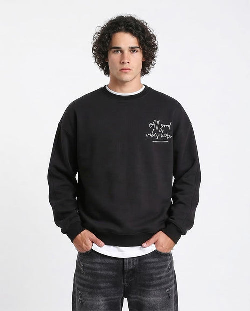 Person wearing a black sweatshirt with text on a white background