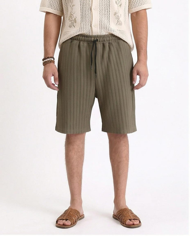 Man wearing olive green shorts on a white background
