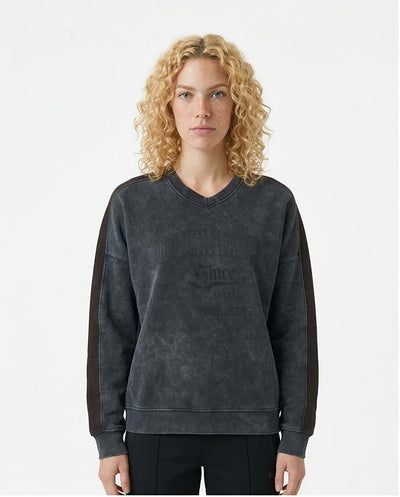 Woman wearing a dark gray sweatshirt with text on a white background