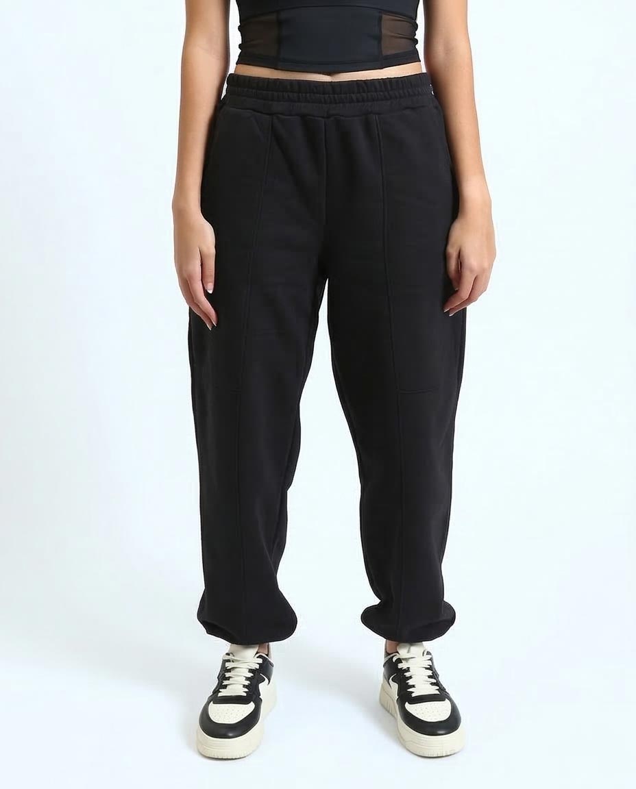 Person wearing black sweatpants on a white background