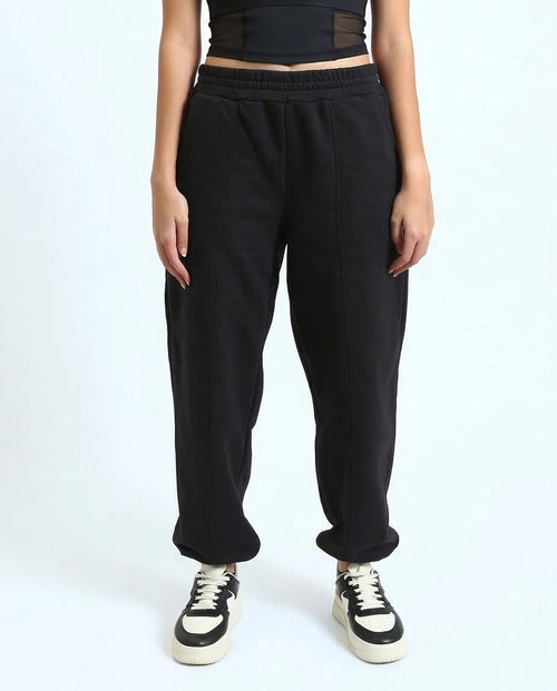 Person wearing black sweatpants on a white background