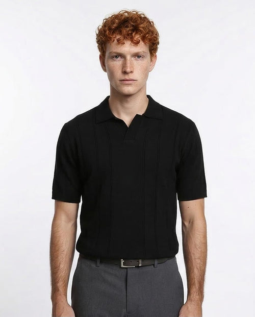 Man wearing a black polo shirt against a white background