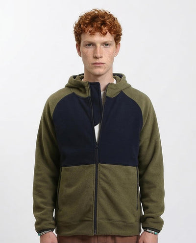 Man wearing a green and navy color-blocked hoodie on a white background
