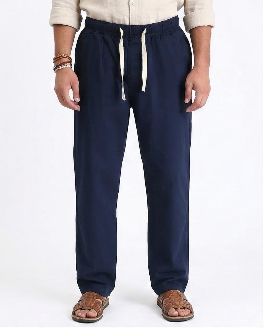 Navy blue pants with a drawstring on a white background