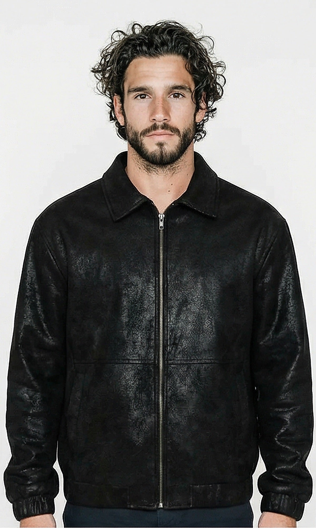 Man wearing a black leather jacket against a white background