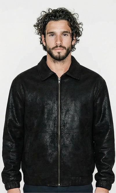 Man wearing a black leather jacket against a white background