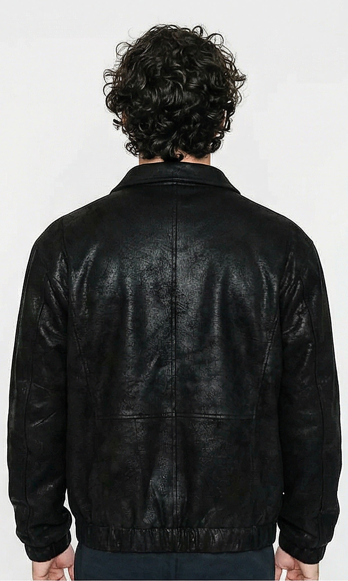 Person wearing a black leather jacket from behind on a white background