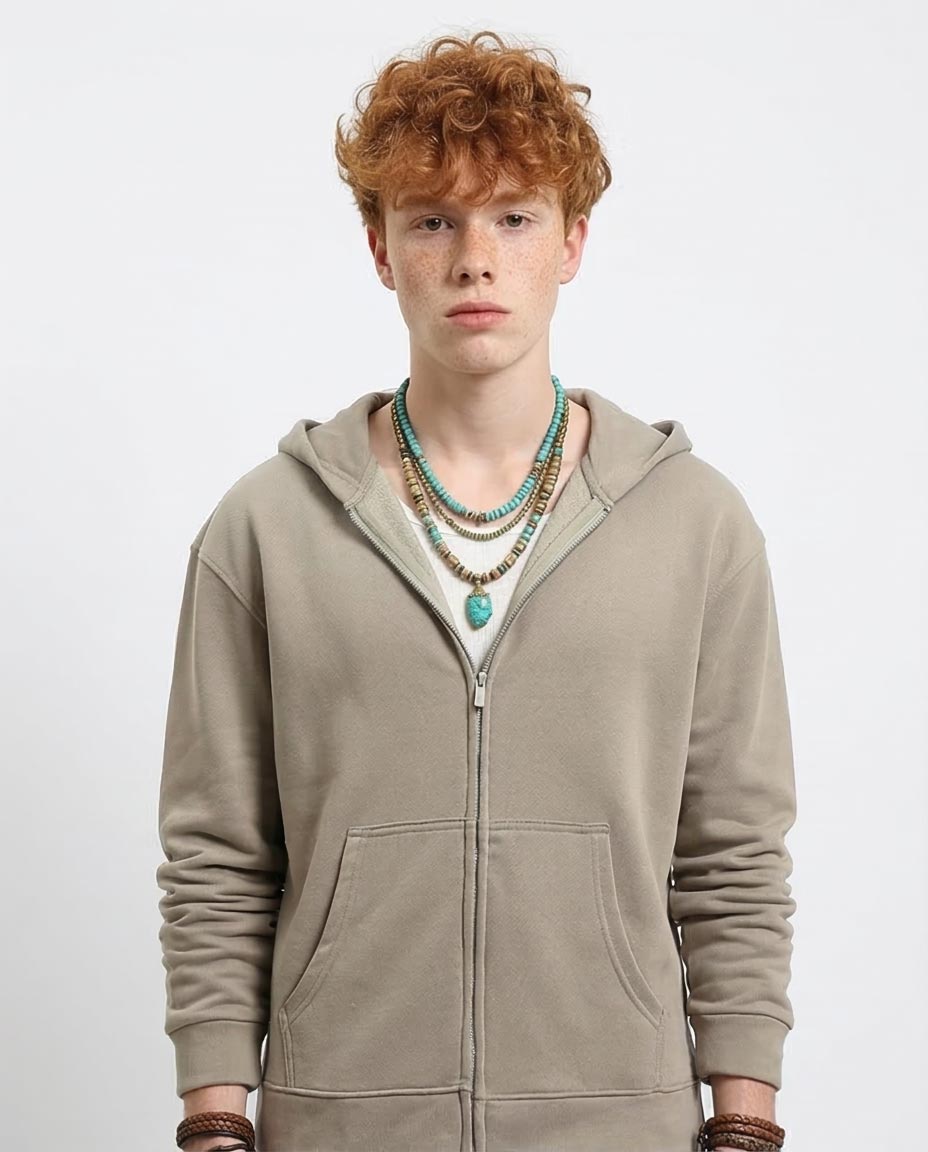 Person wearing a beige hoodie with a plain background