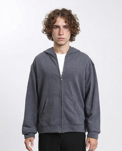 Person wearing a gray hoodie on a white background