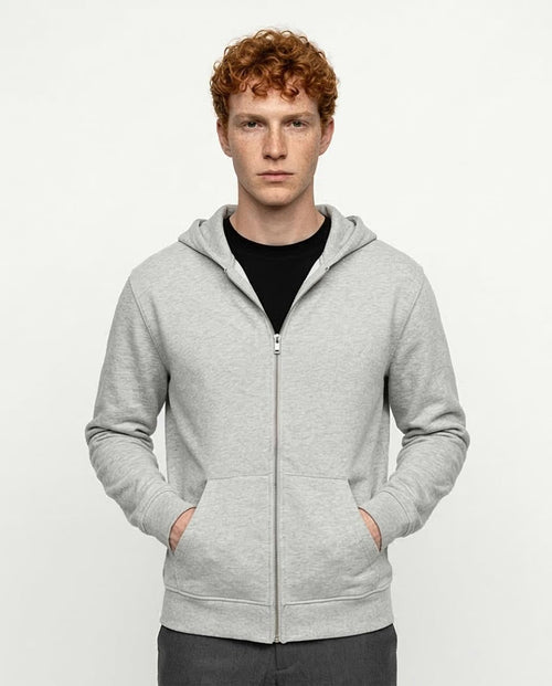 Man wearing a gray hoodie on a white background