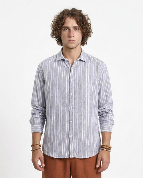 Man wearing a striped shirt and brown pants on a white background