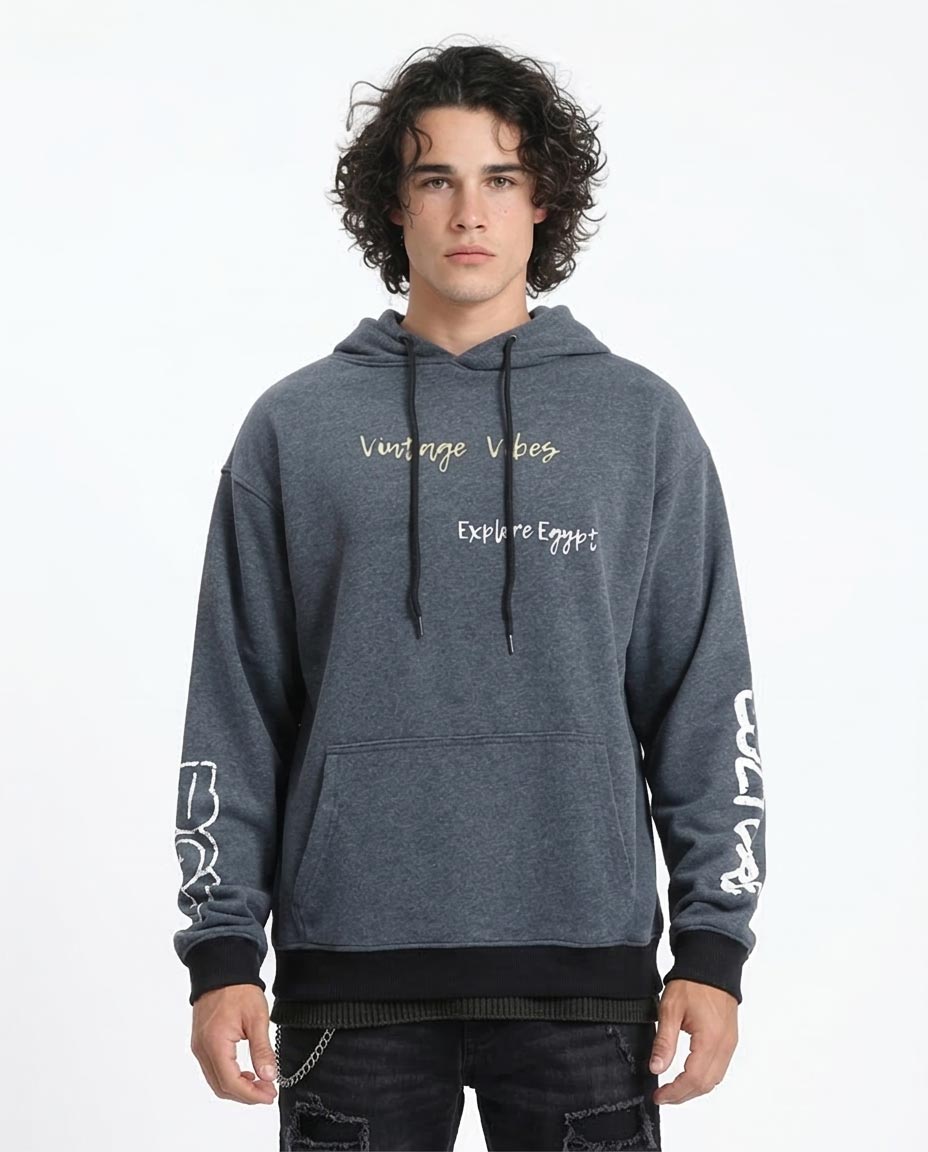 Person wearing a gray hoodie with text on a white background