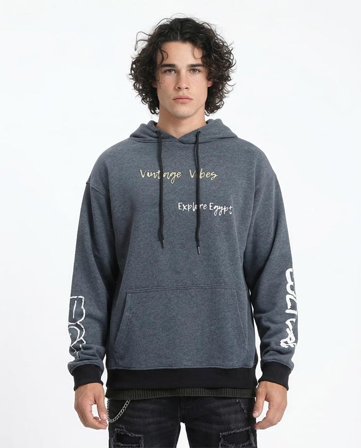 Person wearing a gray hoodie with text on a white background