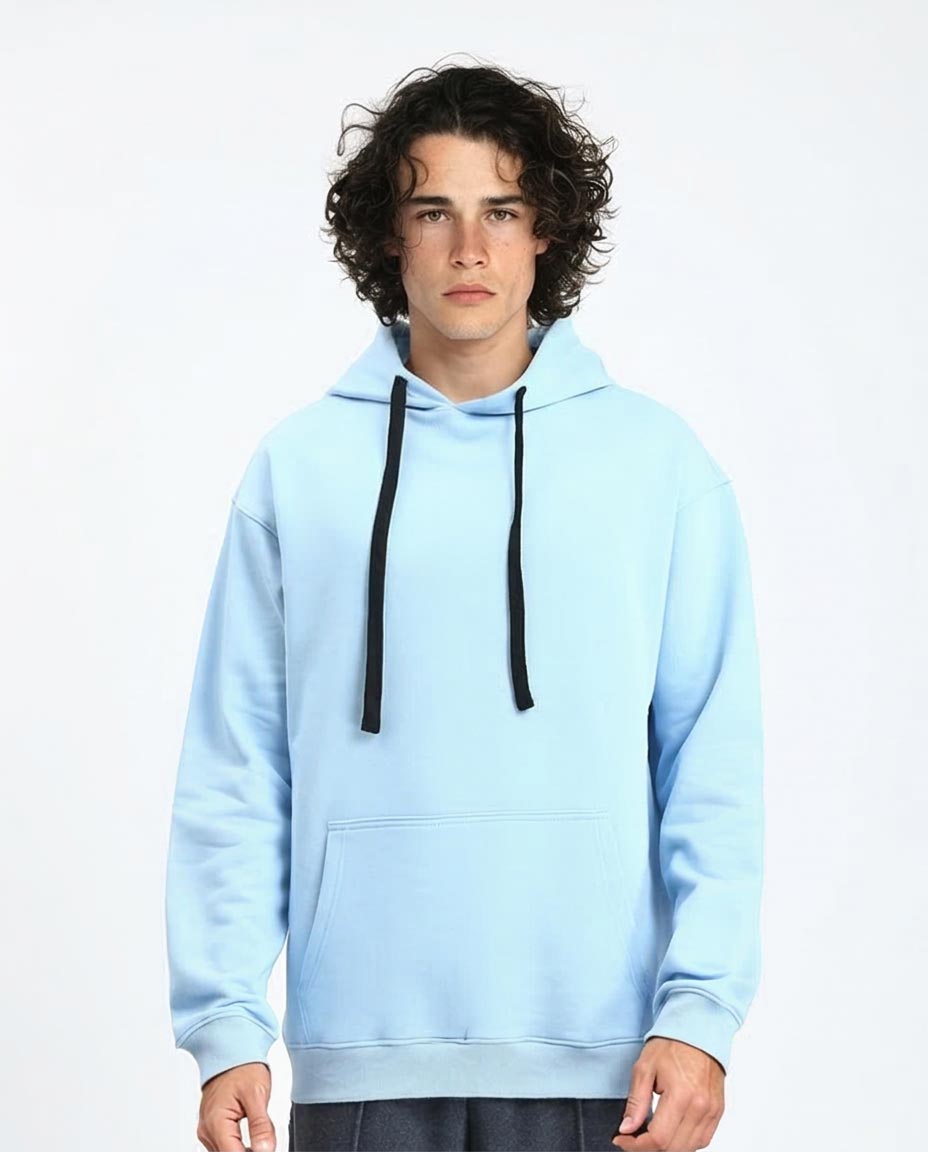 Person wearing a light blue hoodie with black drawstrings on a white background