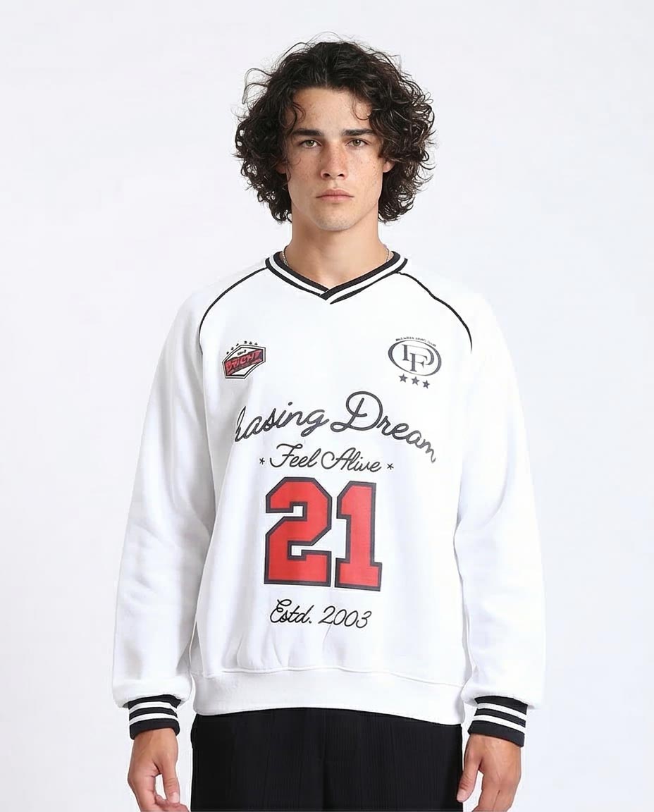 Person wearing a white sweatshirt with text and numbers on a plain background