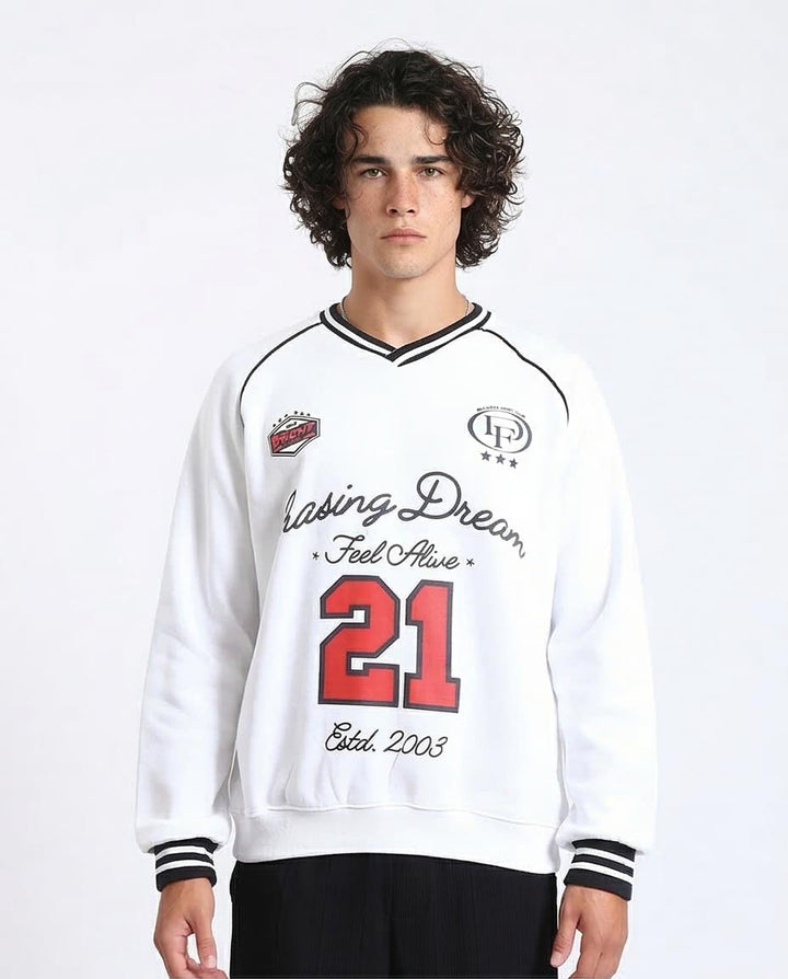 Person wearing a white sweatshirt with text and numbers on a plain background