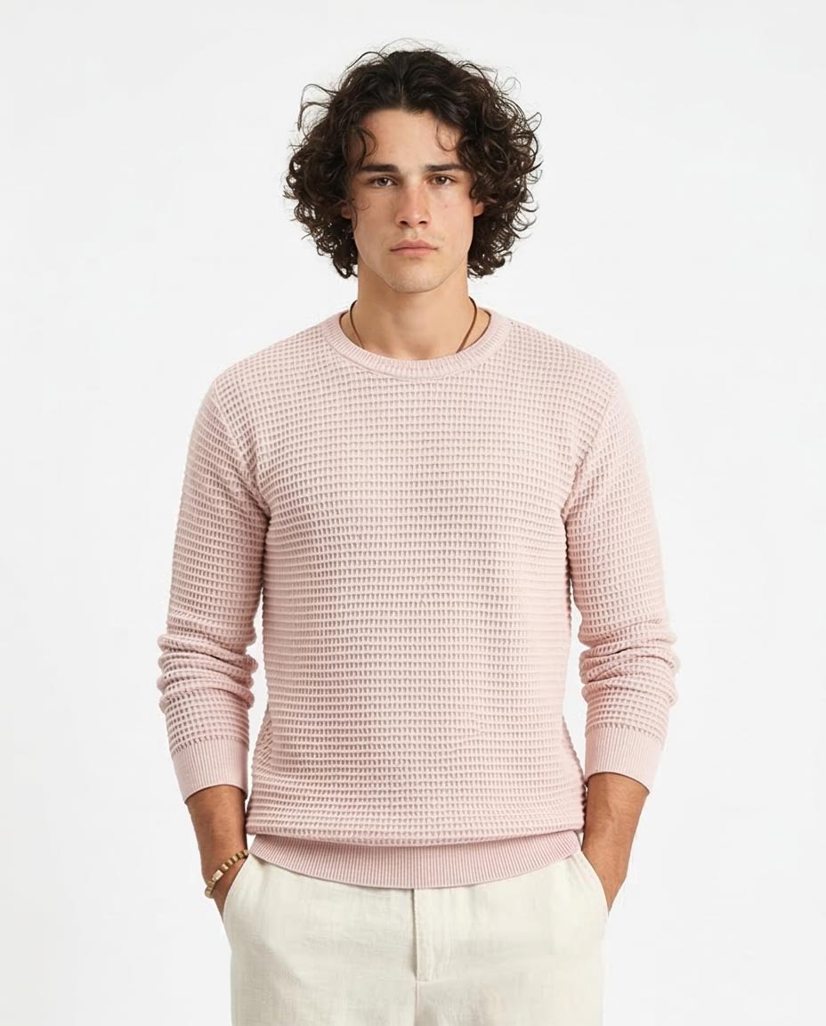 Man wearing a pink textured sweater on a white background