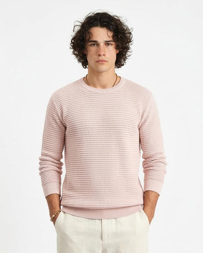 Man wearing a pink textured sweater on a white background