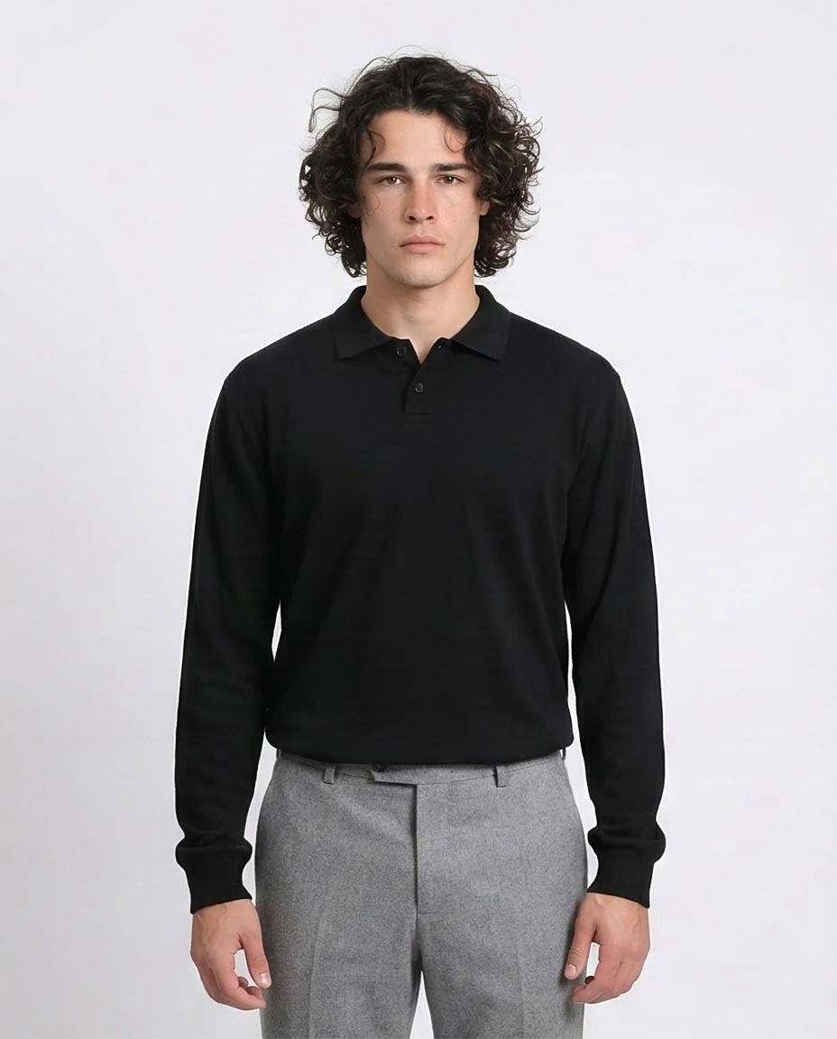 Man wearing a black long-sleeve polo shirt and gray pants on a white background