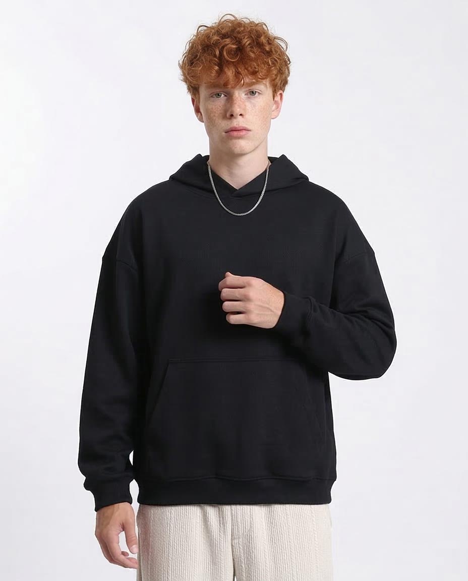 Person wearing a black hoodie on a white background