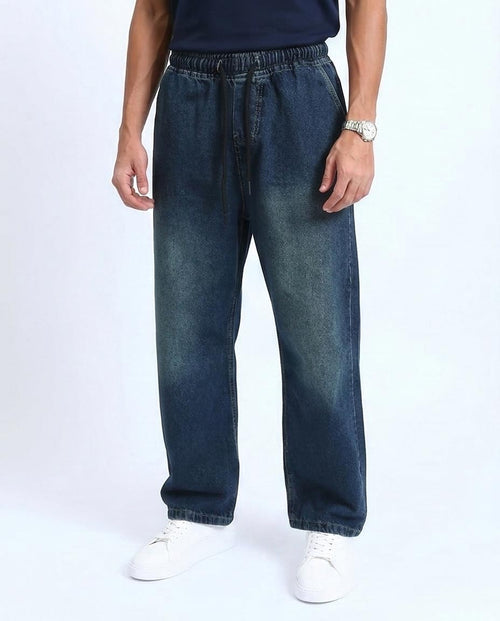 Person wearing blue jeans on a white background