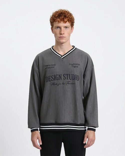 Man wearing a gray sweatshirt with text on a white background