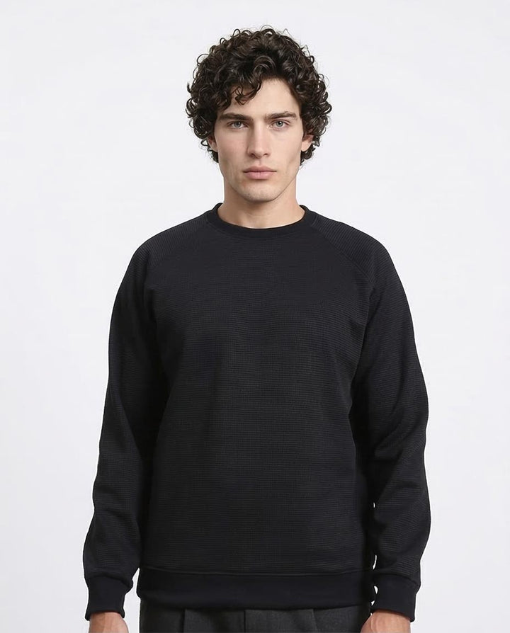 Man wearing a black sweatshirt against a white background